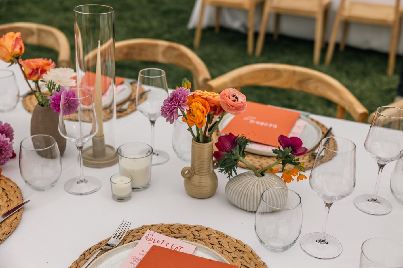 Wedding table set with linen, wine glasses, candles and fresh flowers